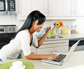 Image showing Woman shopping online at home