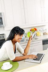 Image showing Woman shopping online at home