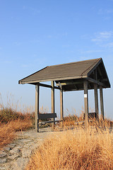 Image showing pavilion on the grassland with blue sky. 