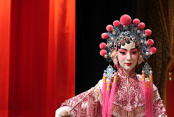 Image showing chinese opera dummy and red cloth as text space ,it is a toy,not