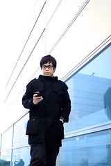 Image showing Business man using cellphone when waiting in station. 