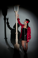 Image showing young woman and lightpole