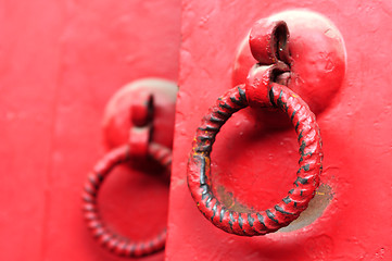 Image showing Red door with iron doorknobs