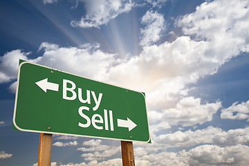 Image showing Buy, Sell Green Road Sign Against Clouds