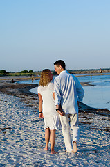 Image showing Young couple walking on beach