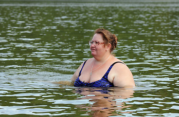 Image showing plump woman bath in river