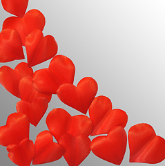 Image showing Petals in heart shape over gray background - frame. Clipping path included.