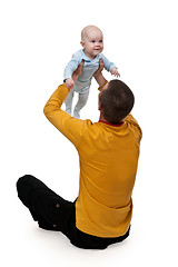 Image showing Dad tosses baby