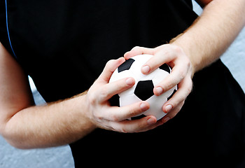 Image showing Holding a soccer ball