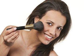 Image showing Beautiful young woman applying foundation powder