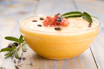 Image showing fresh melon soup with parma ham and lavender flower