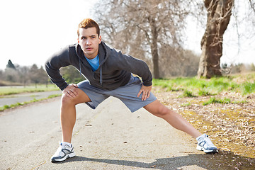 Image showing Mixed race man stretching