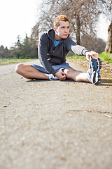 Image showing Mixed race man stretching