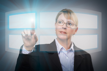 Image showing Woman Pushing an Interactive Touch Screen