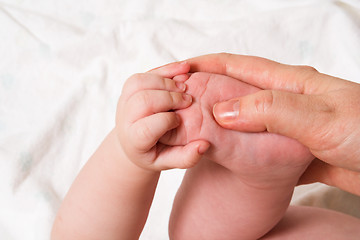 Image showing baby foot in hand