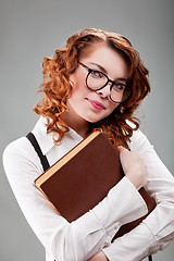 Image showing young woman in glasses with a book