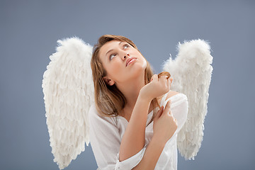 Image showing beautiful blonde angel against grey  background