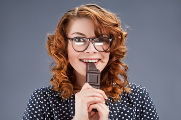 Image showing happy smiling woman eating chocolate