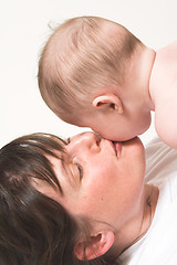 Image showing mother kissing baby on cheek