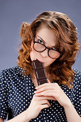 Image showing happy smiling woman eating chocolate