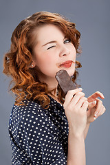 Image showing happy smiling woman eating chocolate