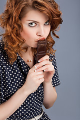 Image showing happy smiling woman eating chocolate