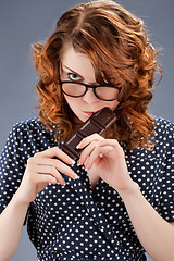 Image showing happy smiling woman eating chocolate