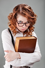 Image showing young woman in glasses with a book