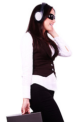 Image showing Beautiful woman listening to music on her headphones 