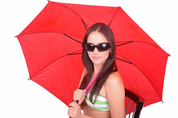 Image showing Beautiful young lady under a red umbrella isolated on white