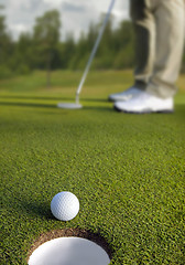 Image showing Golfer putting, selective focus on golf ball 