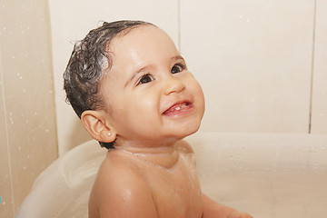 Image showing litlle baby bathes in a bathroom