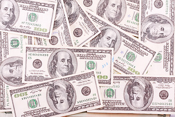 Image showing Bunch of hundred dollar bills with some marks