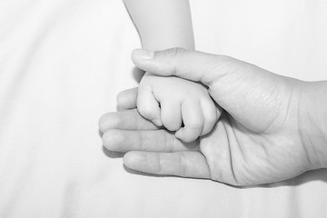 Image showing Father holding daughters hand 