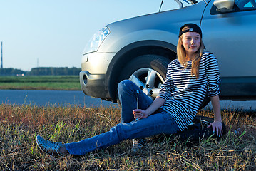 Image showing Young Blond Woman With Her Broken Car