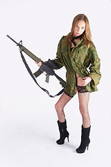 Image showing Woman with gun on white