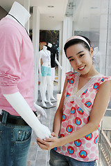 Image showing Asian shop assistant and mannequin