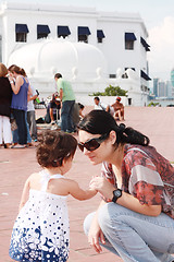 Image showing Mother speaking to her baby in the park