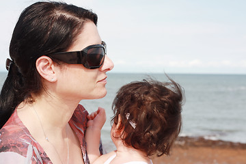 Image showing Mother and daughter enjoy hot summer weather at the beach.