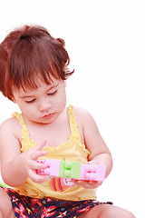 Image showing Baby in yellow shirt playing with toys