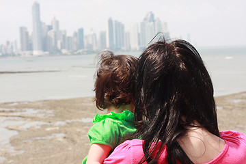 Image showing Mother indicates her baby something interesting in sea 