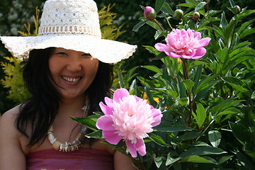 Image showing Girl surrounded of flowers