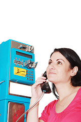 Image showing young happy woman calling from public phone