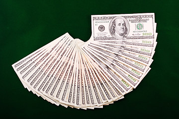 Image showing A combination of dollar fan over a green background