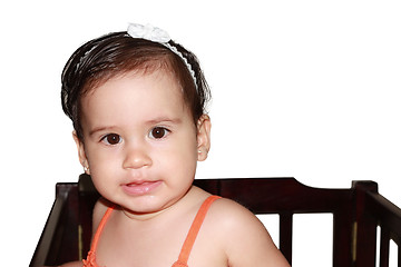 Image showing Infant baby playing in her little baby bed at nursery.