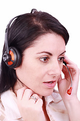 Image showing A beautiful young telephonist speaking on a headset 