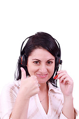 Image showing smiling call center young woman with a headset thumb up 