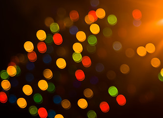 Image showing Blurred festive colorful lights over black 