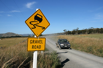 Image showing gravel road warning sign