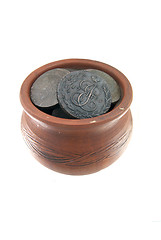 Image showing Old traditional clay mug with ancient coins